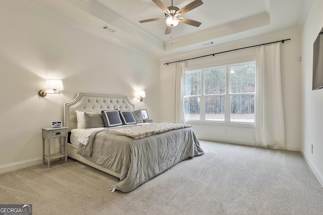 bedroom featuring visible vents, carpet, and a raised ceiling