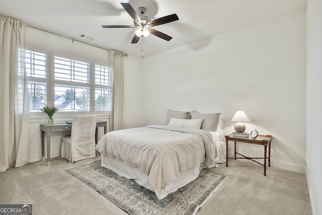bedroom featuring light colored carpet, visible vents, ceiling fan, and baseboards