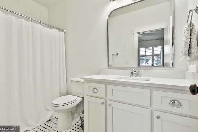 full bathroom with toilet and vanity