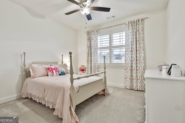 bedroom featuring light colored carpet, visible vents, baseboards, and a ceiling fan