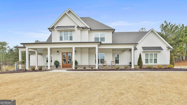 view of front of house featuring covered porch, a front yard, board and batten siding, a shingled roof, and french doors