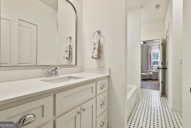 bathroom featuring baseboards, visible vents, and vanity