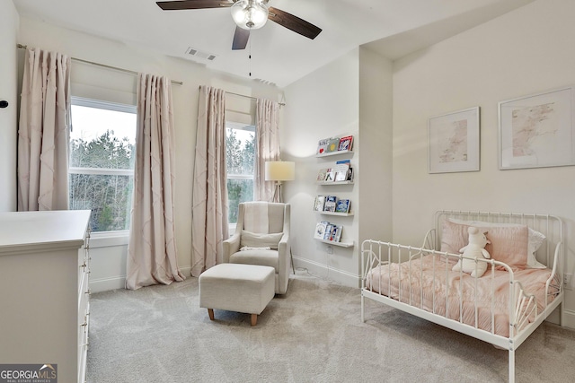 carpeted bedroom featuring a ceiling fan, baseboards, and visible vents