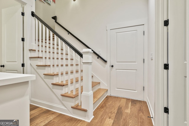 stairway featuring wood finished floors