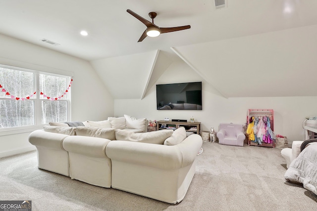 living room with a ceiling fan, carpet, lofted ceiling, and visible vents