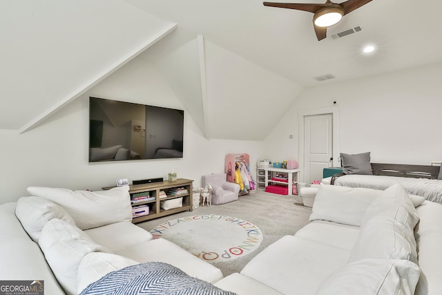 carpeted living room with ceiling fan, vaulted ceiling, and visible vents
