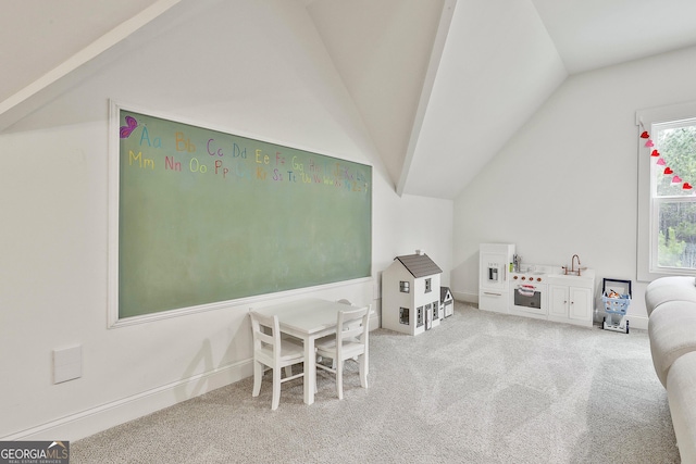 playroom featuring lofted ceiling and carpet