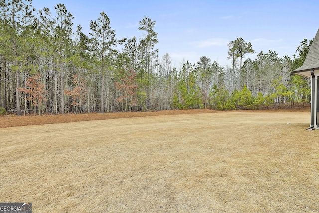 view of yard with a forest view