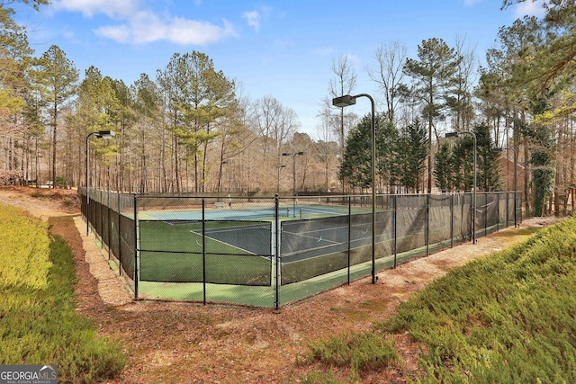 view of tennis court with fence