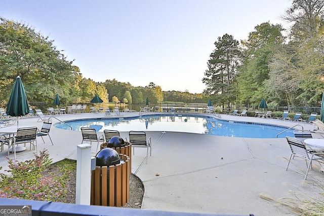 community pool featuring a patio area and fence