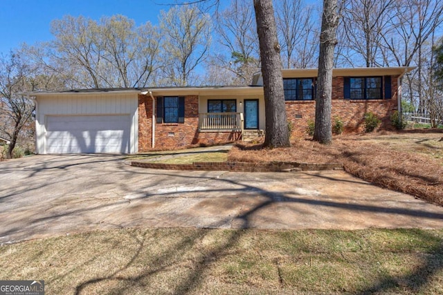 view of front facade featuring a garage, concrete driveway, a porch, and brick siding