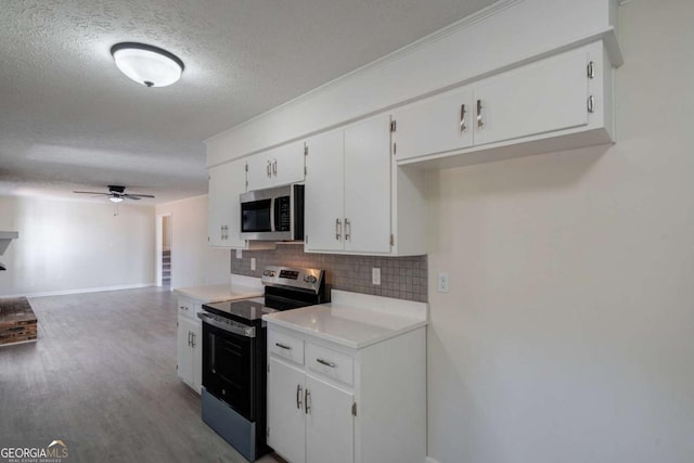 kitchen with decorative backsplash, ceiling fan, a textured ceiling, white cabinets, and stainless steel appliances