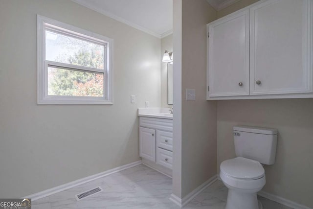 bathroom with visible vents, ornamental molding, marble finish floor, toilet, and baseboards