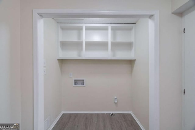 laundry area featuring laundry area, visible vents, wood finished floors, baseboards, and washer hookup