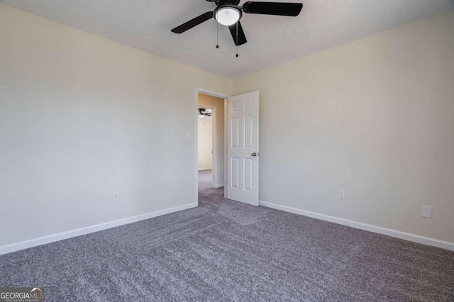 spare room with baseboards, carpet flooring, and ceiling fan