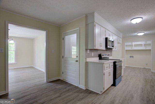 kitchen featuring light countertops, electric range, stainless steel microwave, and light wood-style flooring