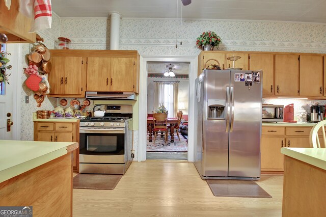 151 Flat Shoals Rd, Woodbury, GA 30293 - kitchen featuring under cabinet range hood, wallpapered walls, light wood-style floors, appliances with stainless steel finishes, and light countertops