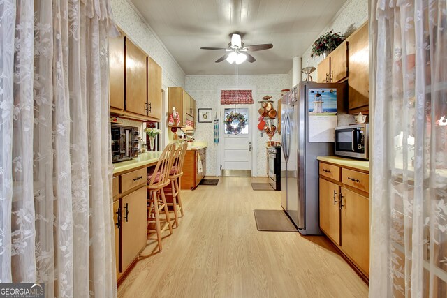 151 Flat Shoals Rd, Woodbury, GA 30293 - kitchen with wallpapered walls, ceiling fan, light countertops, light wood-style flooring, and stainless steel appliances