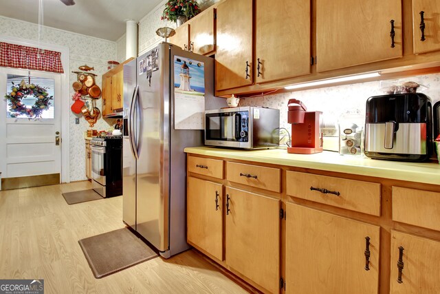 151 Flat Shoals Rd, Woodbury, GA 30293 - kitchen featuring light wood finished floors, appliances with stainless steel finishes, wallpapered walls, and light countertops
