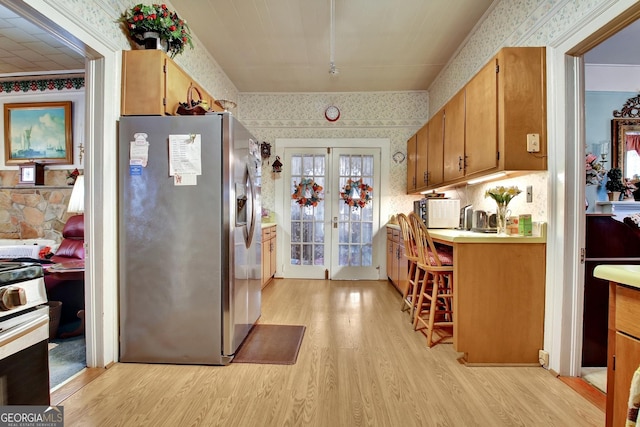151 Flat Shoals Rd, Woodbury, GA 30293 - kitchen featuring wallpapered walls, light wood-style flooring, stainless steel appliances, light countertops, and french doors