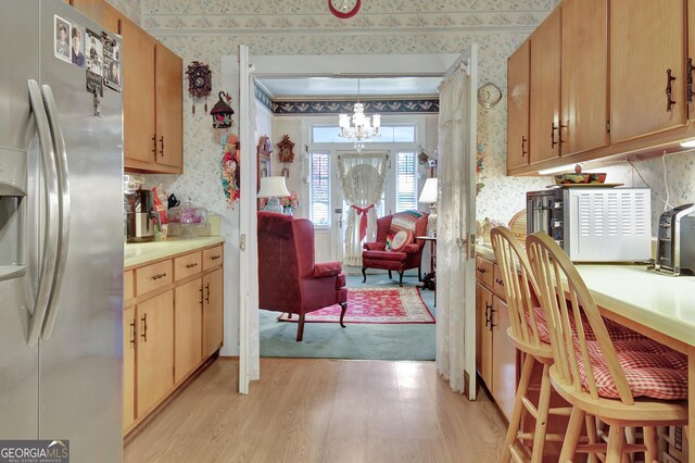 151 Flat Shoals Rd, Woodbury, GA 30293 - kitchen featuring an inviting chandelier, wallpapered walls, light wood-type flooring, and stainless steel refrigerator with ice dispenser