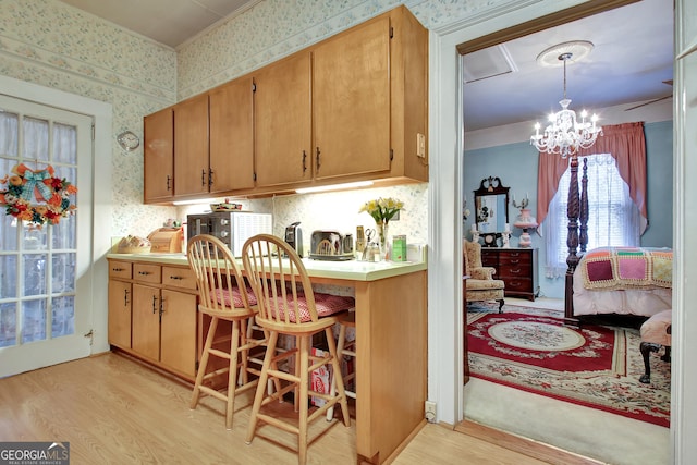 151 Flat Shoals Rd, Woodbury, GA 30293 - kitchen featuring a chandelier, wallpapered walls, and light wood-style floors