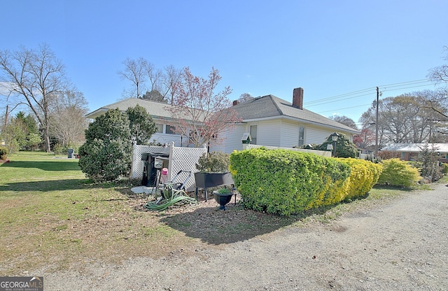 151 Flat Shoals Rd, Woodbury, GA 30293 - view of home's exterior with a lawn and a chimney