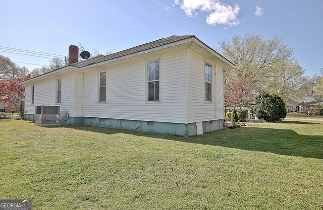 151 Flat Shoals Rd, Woodbury, GA 30293 - view of side of property with crawl space, central air condition unit, a lawn, and a chimney
