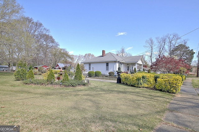 151 Flat Shoals Rd, Woodbury, GA 30293 - view of front of property with a chimney, a front yard, and fence