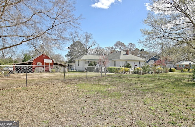 151 Flat Shoals Rd, Woodbury, GA 30293 - exterior space with a barn, a front lawn, fence, a chimney, and an outbuilding
