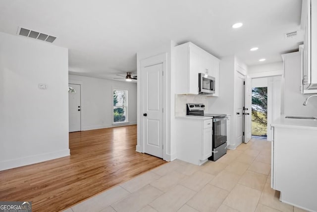 5225 Maple Valley Rd SW, Mableton, GA 30126 - kitchen with appliances with stainless steel finishes, plenty of natural light, light countertops, a ceiling fan, and recessed lighting