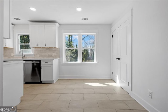 5225 Maple Valley Rd SW, Mableton, GA 30126 - kitchen with dishwasher, light countertops, white cabinetry, backsplash, and recessed lighting