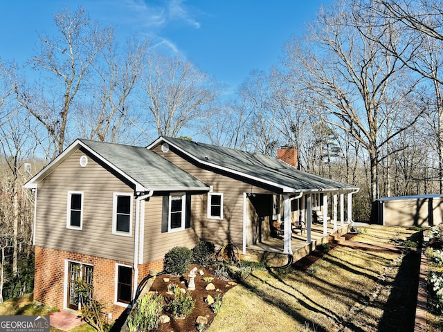 285 W0Lf Den Rd, Royston, GA 30662 - view of side of home featuring brick siding, a chimney, a shingled roof, an outbuilding, and covered porch