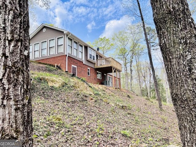 285 W0Lf Den Rd, Royston, GA 30662 - back of house with brick siding, a deck, and central AC