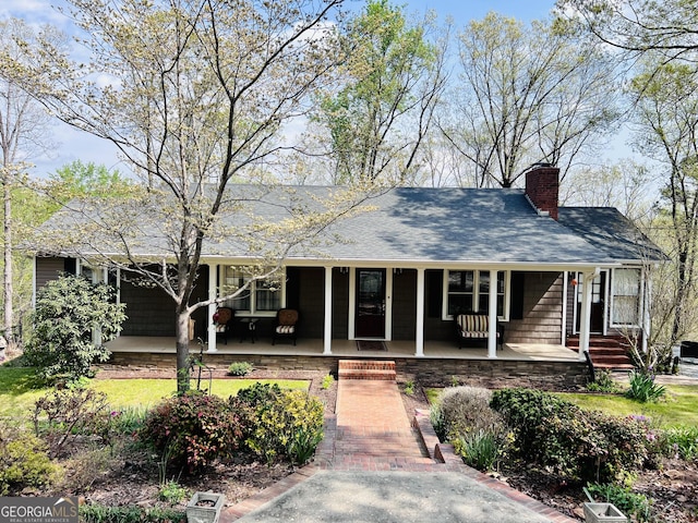 285 W0Lf Den Rd, Royston, GA 30662 - view of front facade featuring a porch, a chimney, and a shingled roof