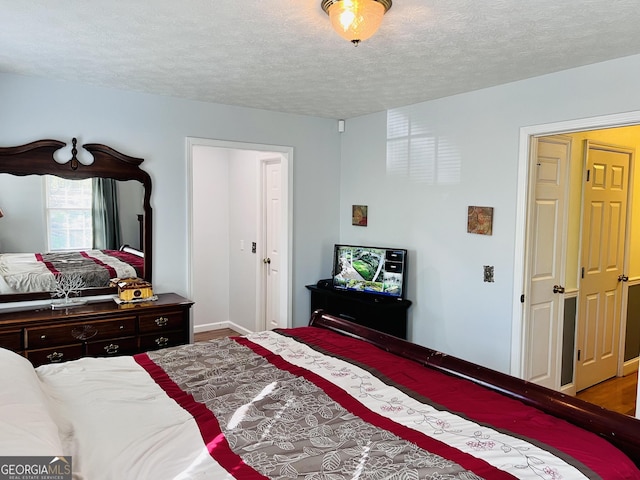285 W0Lf Den Rd, Royston, GA 30662 - bedroom with wood finished floors, a textured ceiling, and baseboards
