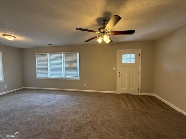 1643 Columbia Dr, Decatur, GA 30032 - foyer entrance with baseboards and dark carpet