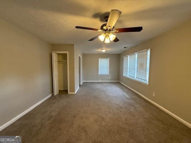 1643 Columbia Dr, Decatur, GA 30032 - unfurnished bedroom with carpet flooring, baseboards, a closet, and a textured ceiling