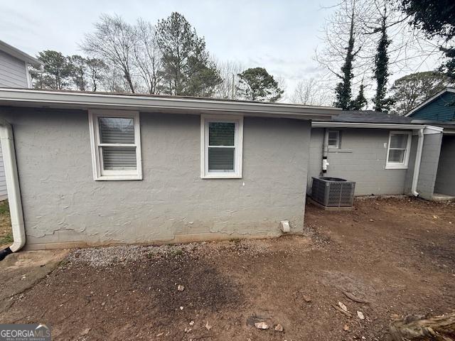 192 Margaret St, Fairburn, GA 30213 - view of side of property with stucco siding and cooling unit