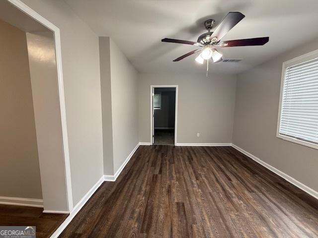 192 Margaret St, Fairburn, GA 30213 - empty room featuring baseboards, visible vents, dark wood-style flooring, and ceiling fan