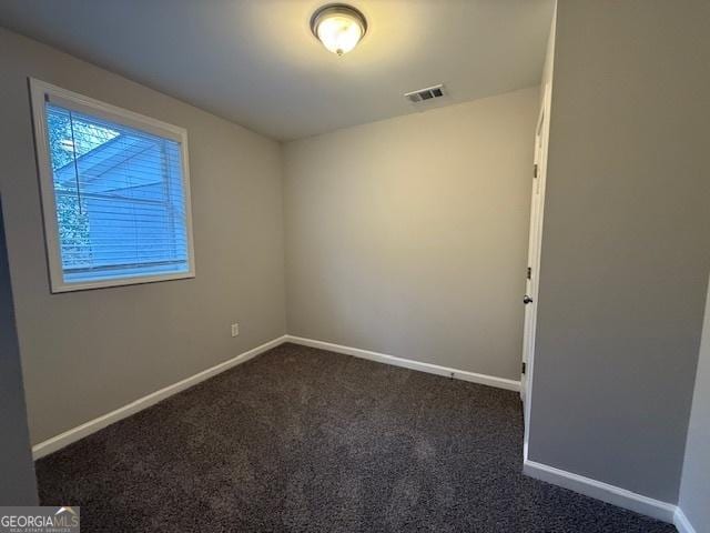 192 Margaret St, Fairburn, GA 30213 - empty room featuring baseboards, visible vents, and dark colored carpet