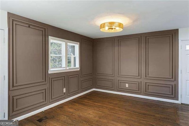 empty room with visible vents and dark wood-style flooring