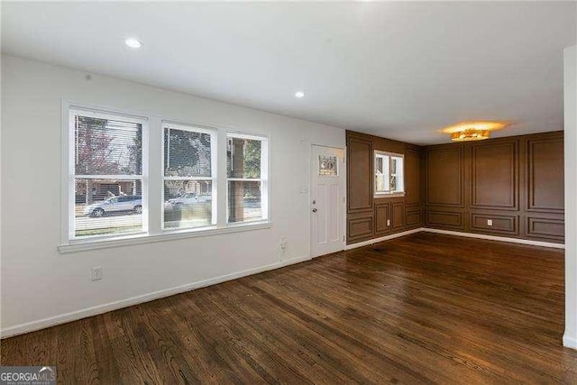 interior space featuring dark wood finished floors, recessed lighting, and baseboards