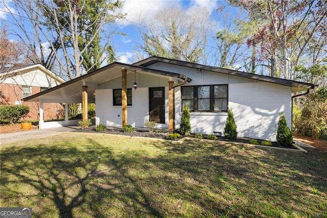 view of front of house with driveway, an attached carport, and a front yard