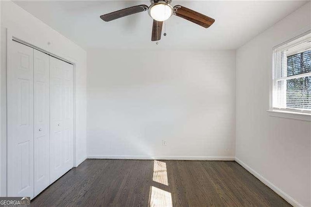 unfurnished bedroom featuring a closet, a ceiling fan, baseboards, and wood finished floors