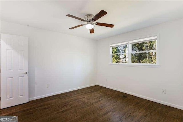 spare room featuring ceiling fan, baseboards, and wood finished floors
