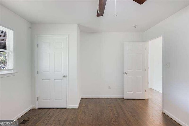 unfurnished bedroom with ceiling fan, visible vents, baseboards, and wood finished floors