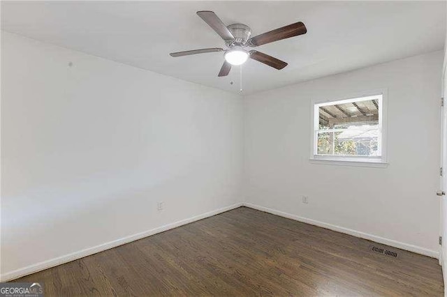 unfurnished room featuring visible vents, baseboards, wood finished floors, and a ceiling fan