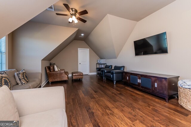 living area featuring visible vents, ceiling fan, dark wood finished floors, ornamental molding, and a fireplace