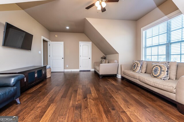 living area featuring baseboards, visible vents, dark wood-style flooring, ornamental molding, and ceiling fan with notable chandelier